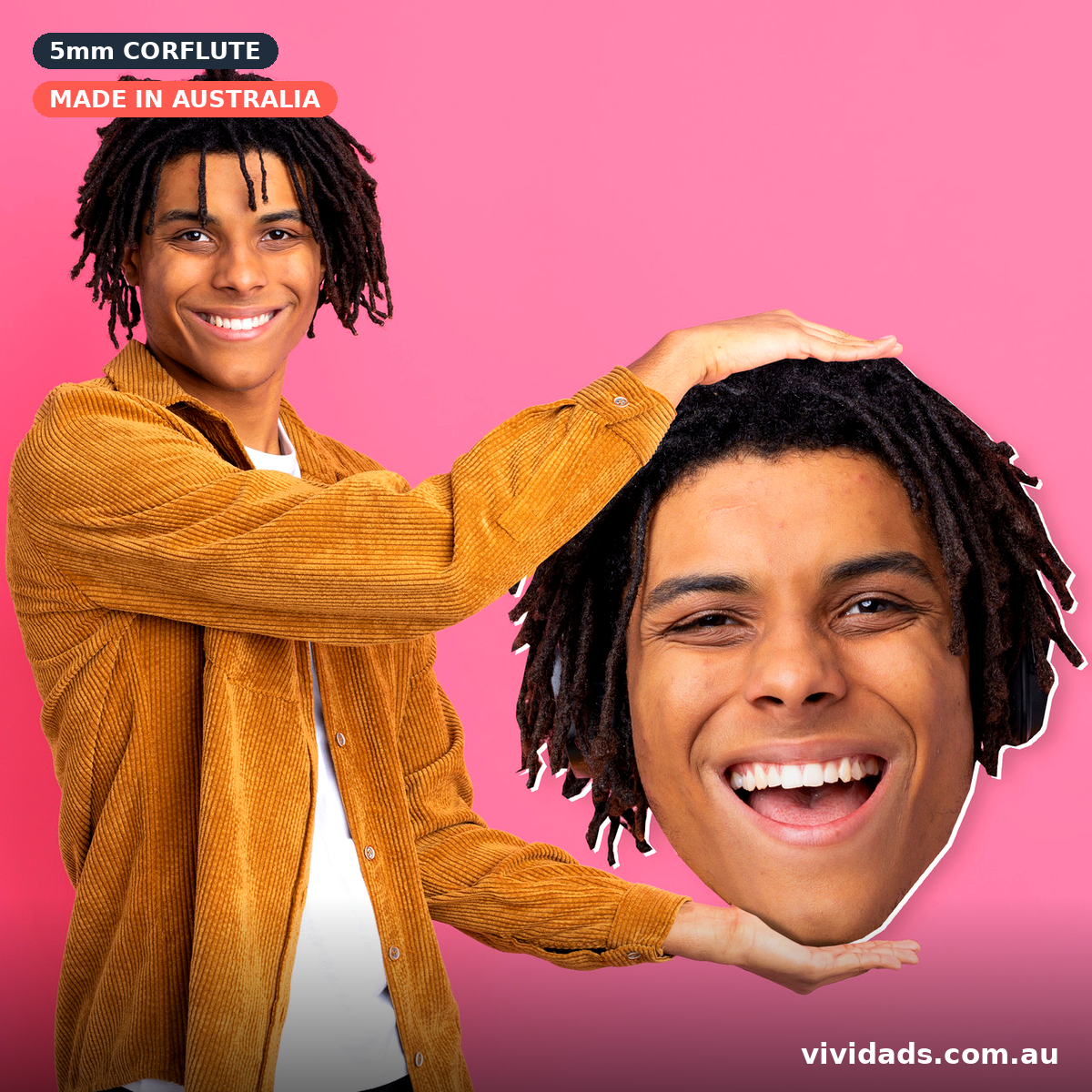 Person holding a custom big head face cutout on a pink background