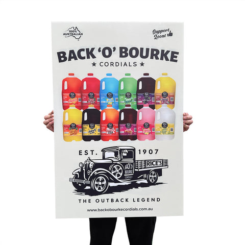 Large printed corflute sign held up, showing a full-colour cordial brand advertisement